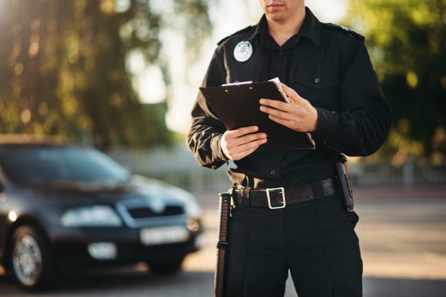cop-with-notebook-hands-check-car