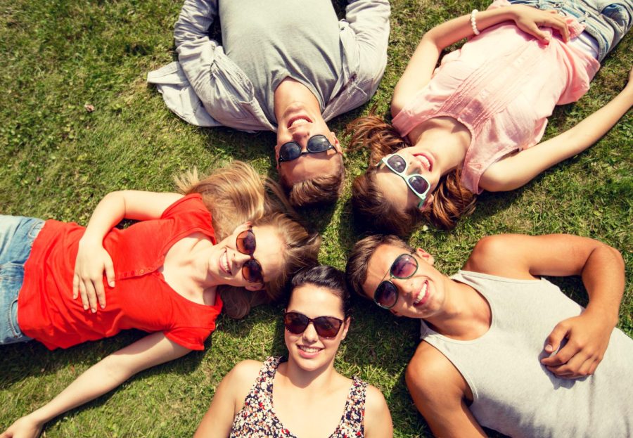 friendship-leisure-summer-people-concept-group-smiling-friends-lying-grass-circle-outdoors