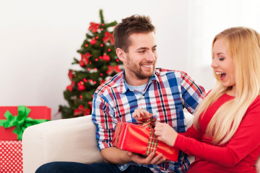 happy-couple-have-fun-during-opening-christmas-present