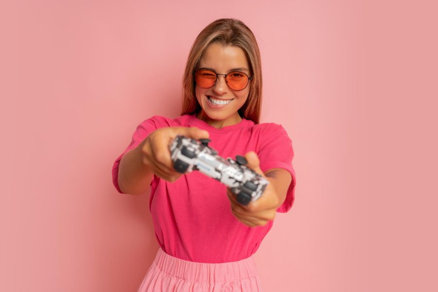 studio-photo-happy-excited-crazy-smiling-woman-playing-videogames-addicted-playstation-isolated-pink-color-background