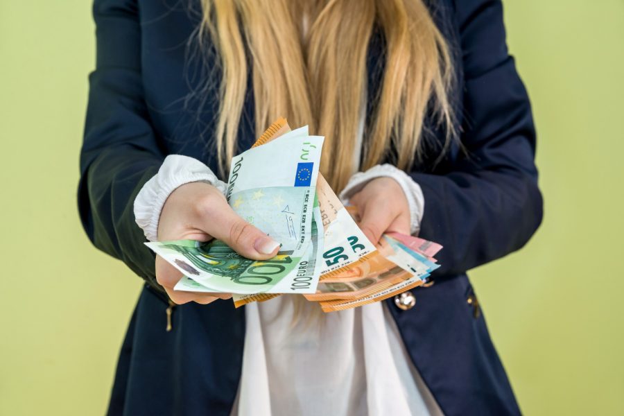 woman-holding-euro-banknotes-isolated-green